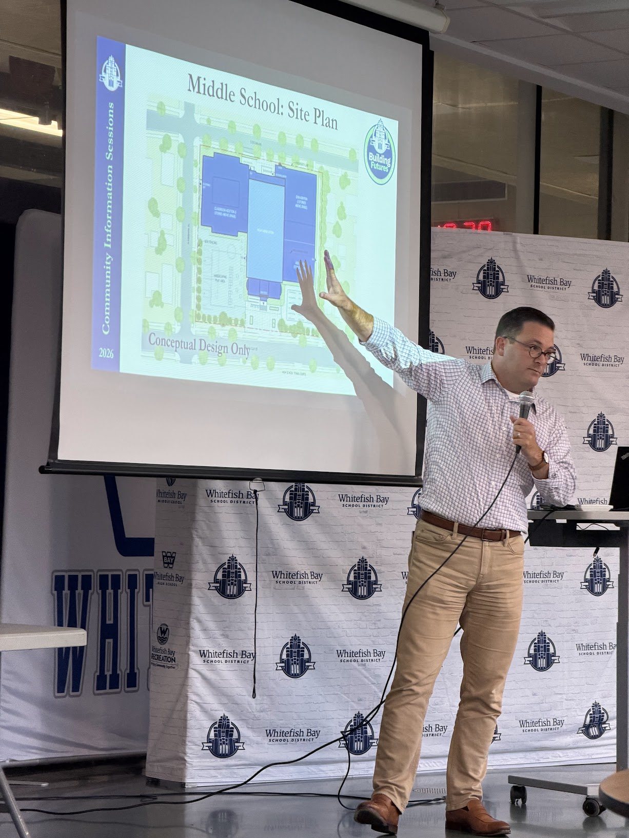 A presenter discusses the conceptual middle school site plan